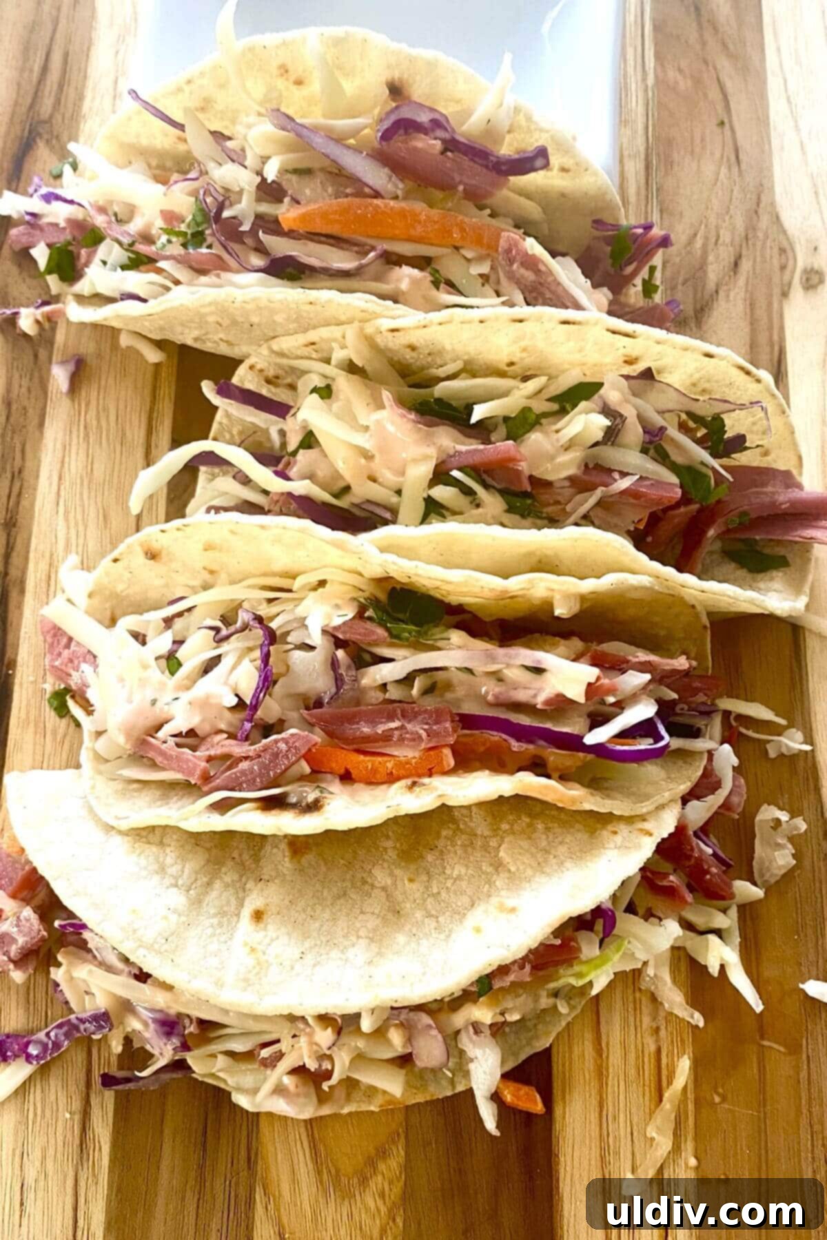 Irish Tacos: The Corned Beef & Cabbage Twist 9 Several Irish corned beef tacos arranged neatly on a wooden cutting board, ready to be served.