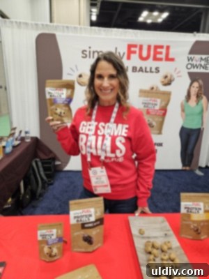 Unwrapping the 2025 Sweets & Snacks Expo 17 Mitzi Dulan, owner of Simply Fuel, presenting her delicious protein balls at the Sweets & Snacks Expo.