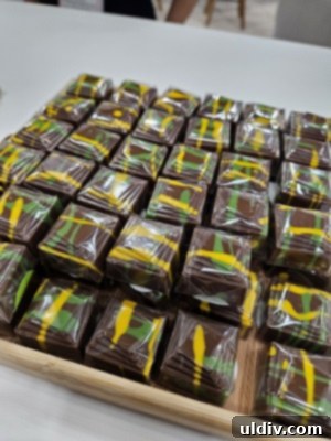 Unwrapping the 2025 Sweets & Snacks Expo 6 A close-up of a chocolate bar filled with a green pistachio cream and crunchy kataifi, a stunning example of Dubai chocolate.