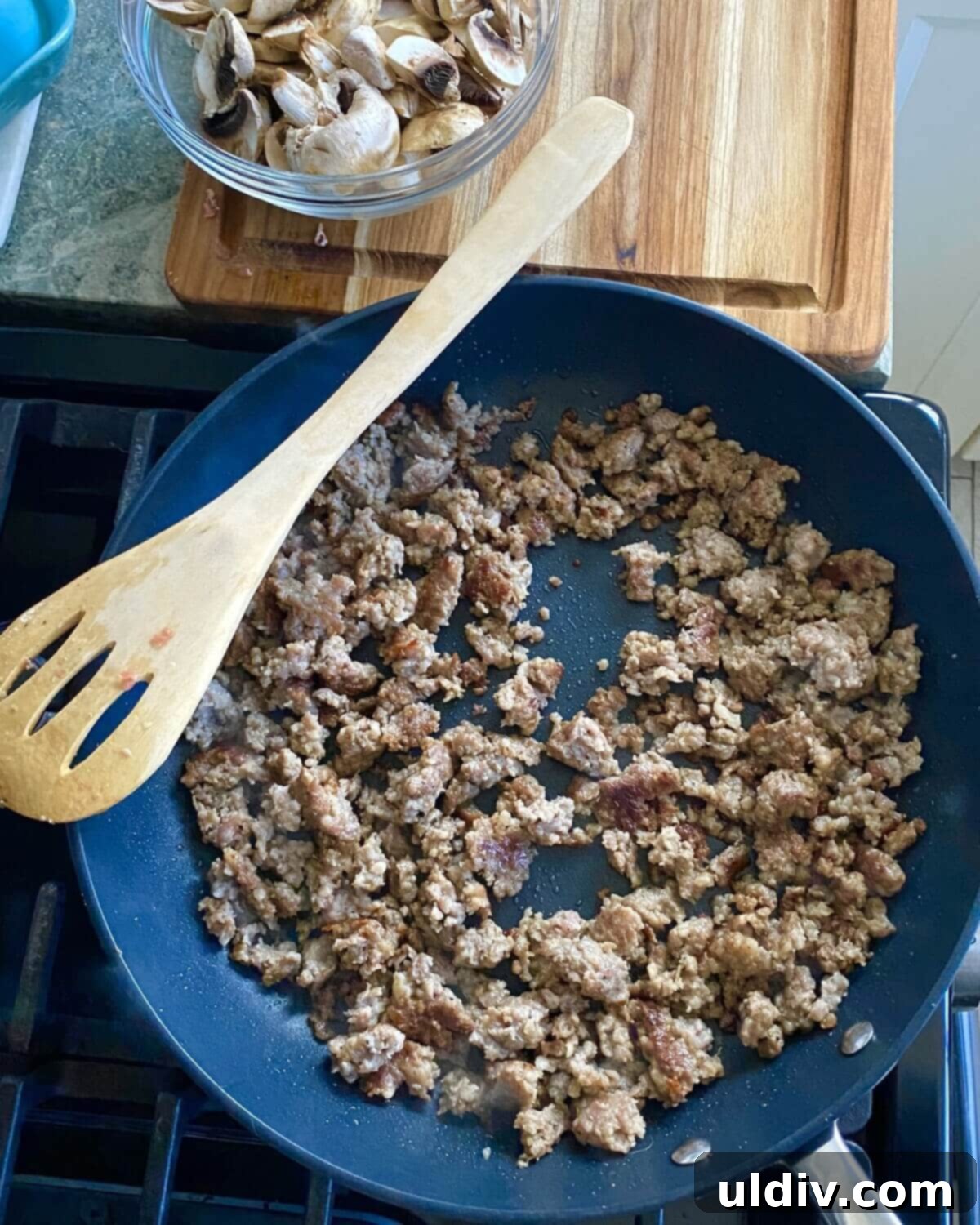 Loaded Breakfast Egg Bake with Sausage, Spinach, Mushrooms, and Croutons 6 cooked sausage in a pan.