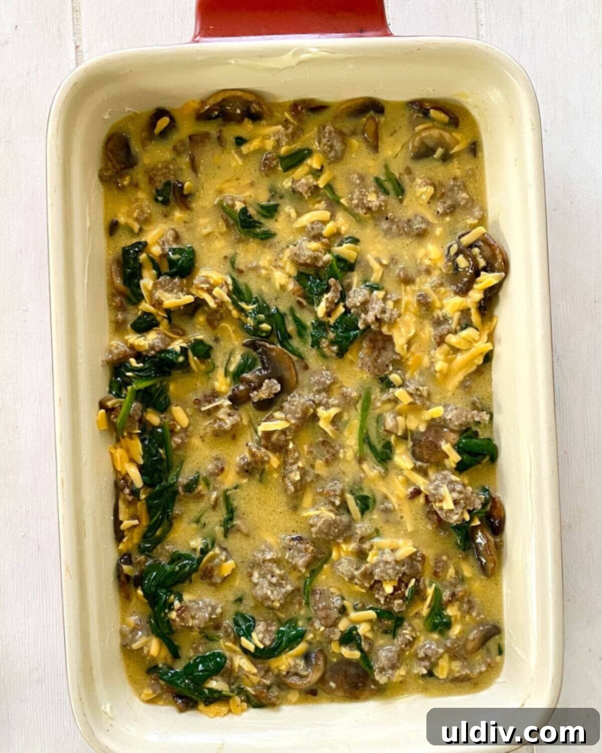 Sausage, Mushroom & Spinach Breakfast Strata 10 The unbaked egg casserole mixture poured into the prepared baking dish, smooth and ready for topping.