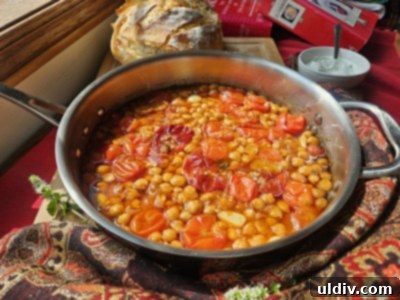 Confit Tandoori Chickpeas: A Fusion of Flavors 4 A close-up of the raw ingredients laid out before cooking, including vibrant cherry tomatoes, garlic, ginger, and a selection of colorful spices, ready for the Confit Tandoori Chickpea preparation.