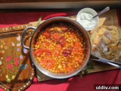 Confit Tandoori Chickpeas: A Fusion of Flavors 5 A wider shot of the prepared ingredients, including a bowl of chickpeas, alongside chopped tomatoes, garlic, ginger, and small bowls of various spices, showing the fresh components of the dish.
