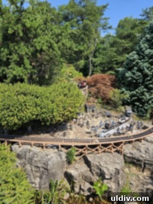 Miniature trains traversing a meticulously crafted landscape in the Railway Garden at Gabis Arboretum