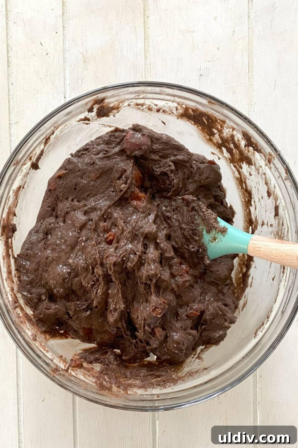 The chocolate cherry cake batter in a large bowl, showing its thick, rich consistency and visible cherry pieces.