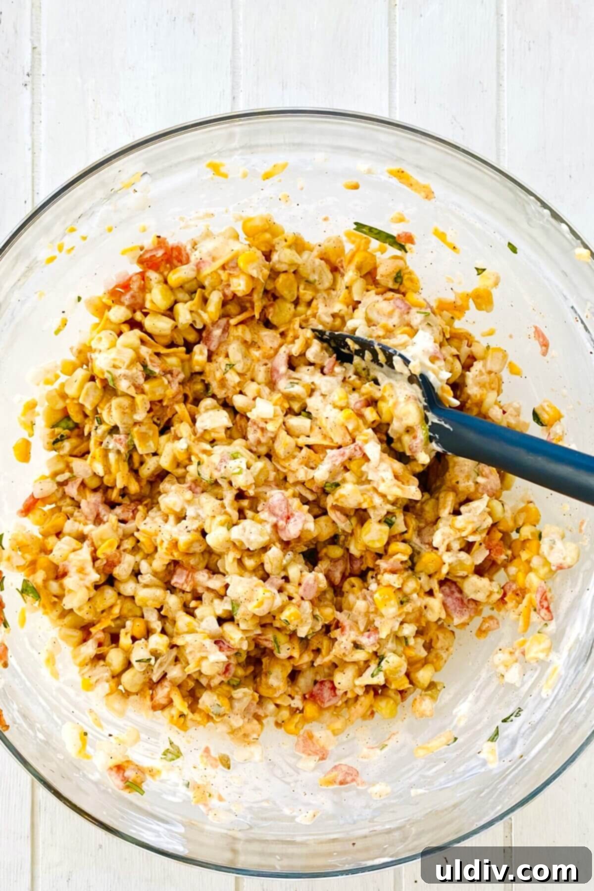 Baked Cheesy Corn Delight 7 mixed corn dip in a bowl.