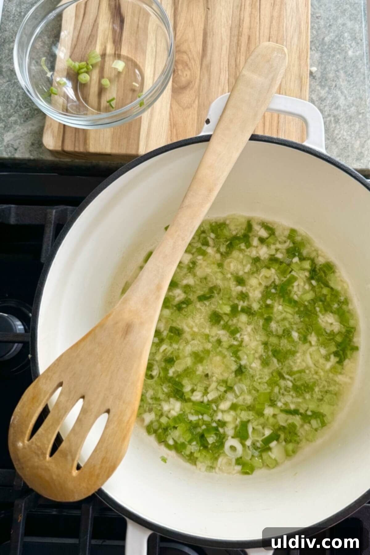 Effortless One-Pot Garlic Sesame Noodles 7 Chopped green onions and minced garlic being sautéed in a pan with butter.