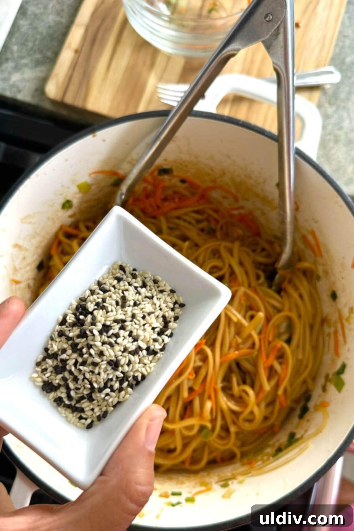 One-Pot Garlic Sesame Noodles 9 adding sesame seeds to noodles.