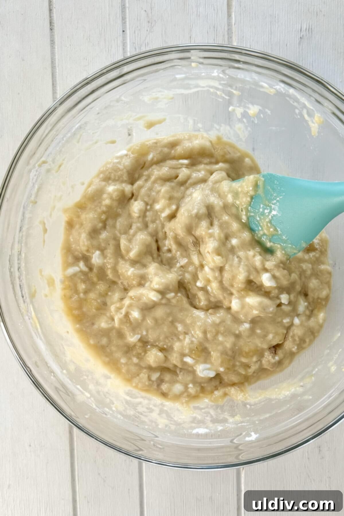 Wholesome Banana Cottage Cheese Protein Pancakes 8 A smooth, lump-free protein pancake batter in a clear glass bowl, covered with plastic wrap, resting.