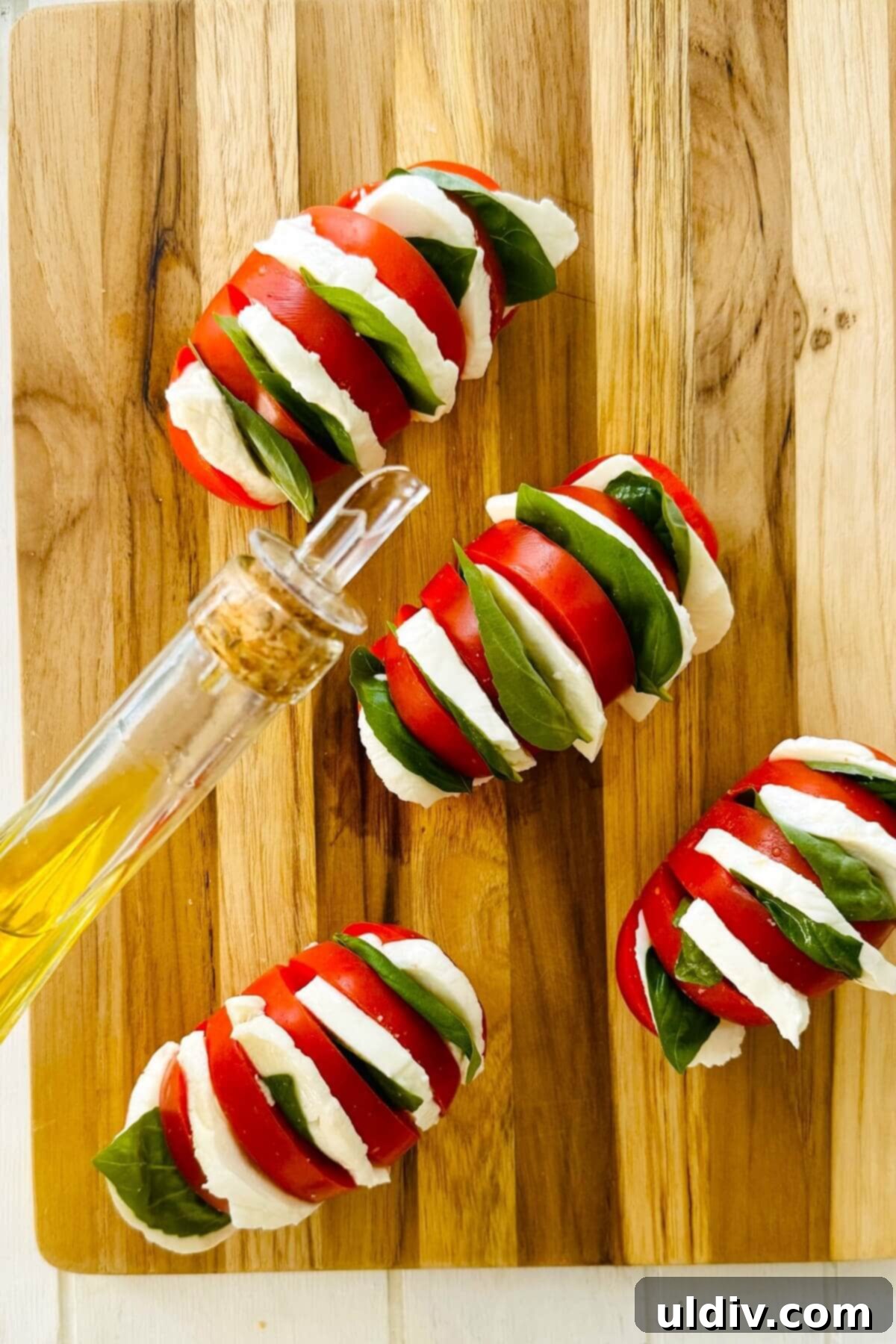 Caprese Stuffed Tomatoes 6 olive oil and stuffed tomatoes with mozzarella and basil.
