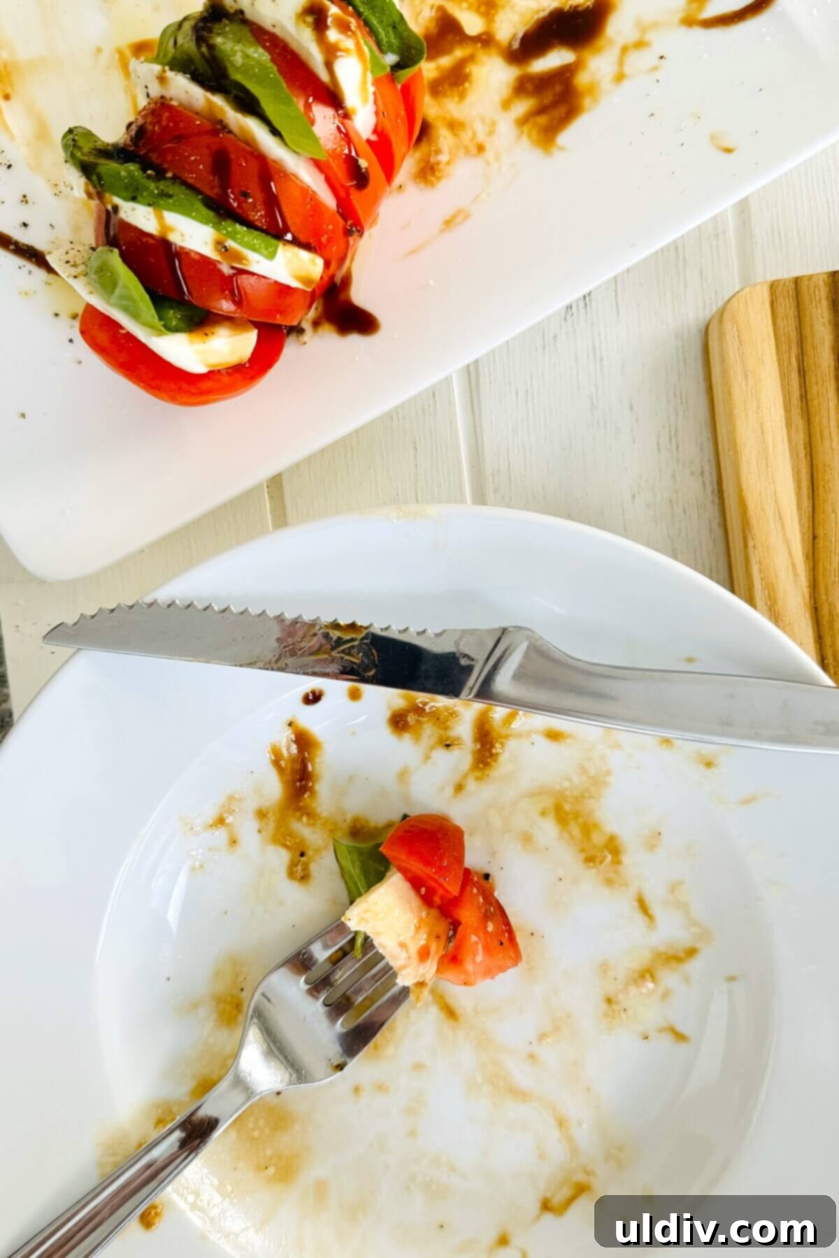 Caprese Stuffed Tomatoes 8 a bite of caprese salad on a fork.