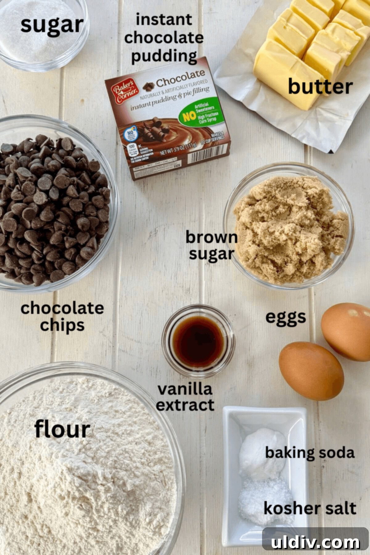 Double Chocolate Pudding Cookies 4 A flat lay of cookie ingredients including chocolate chips, flour, instant pudding mix, eggs, vanilla, butter, baking soda, kosher salt, brown sugar, and granulated sugar.