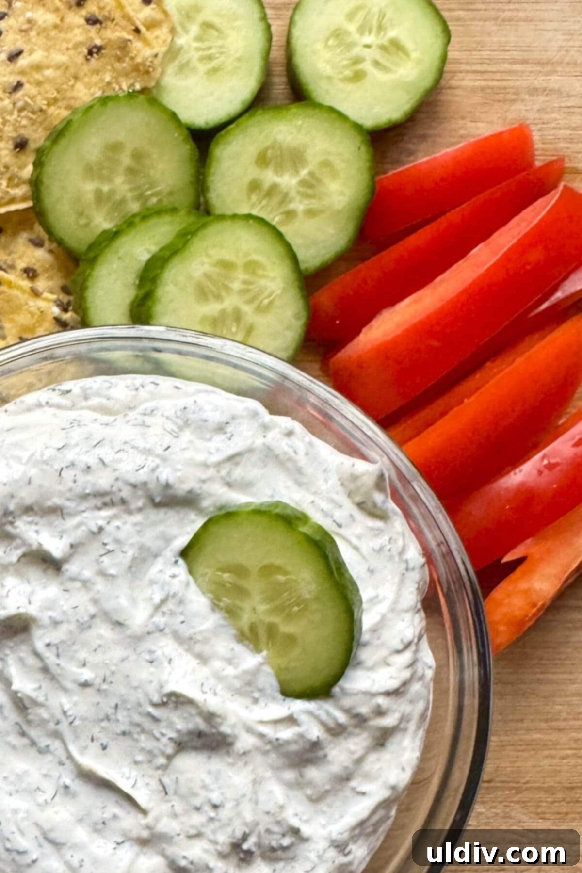 Easy 5-Minute Dill Dip 3 A bowl of fresh homemade dill dip, served with crisp cucumber slices, inviting a refreshing dip.
