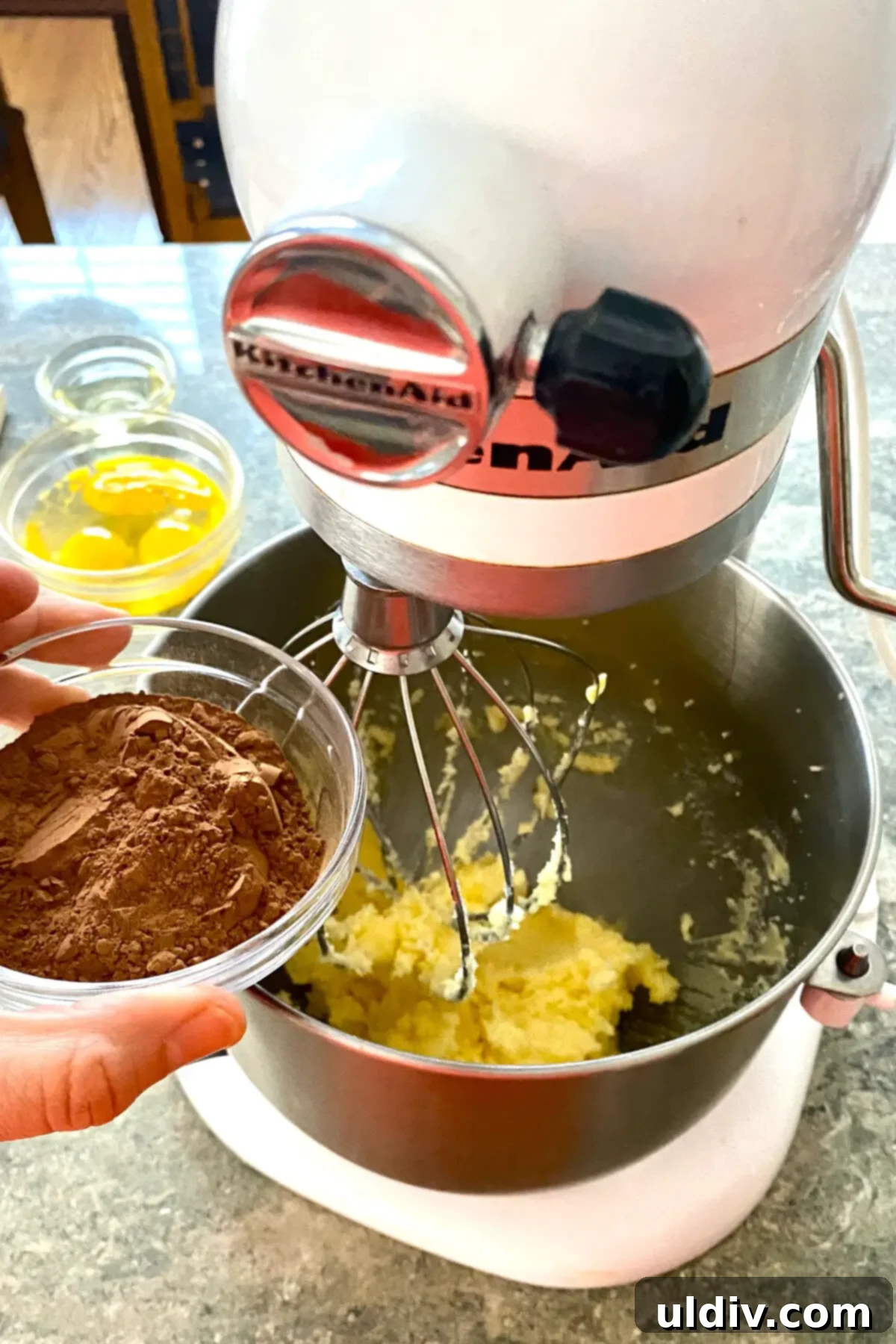 The Ultimate French Silk Pie Recipe Surpassing Bakers Square 6 adding cocoa to French silk pie filling in mixing bowl.