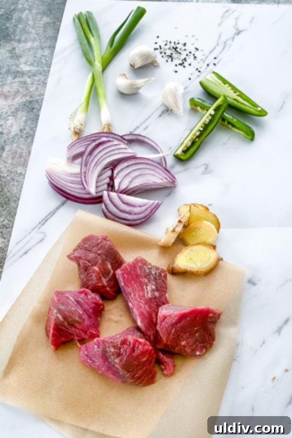 meat, red onion, ginger root slices, garlic, jalapeno, and scallions
