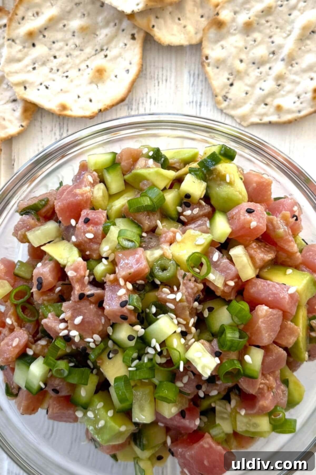 Fast and Fresh Tuna Ceviche 2 A bowl of tuna ceviche with water crackers, showcasing vibrant colors.