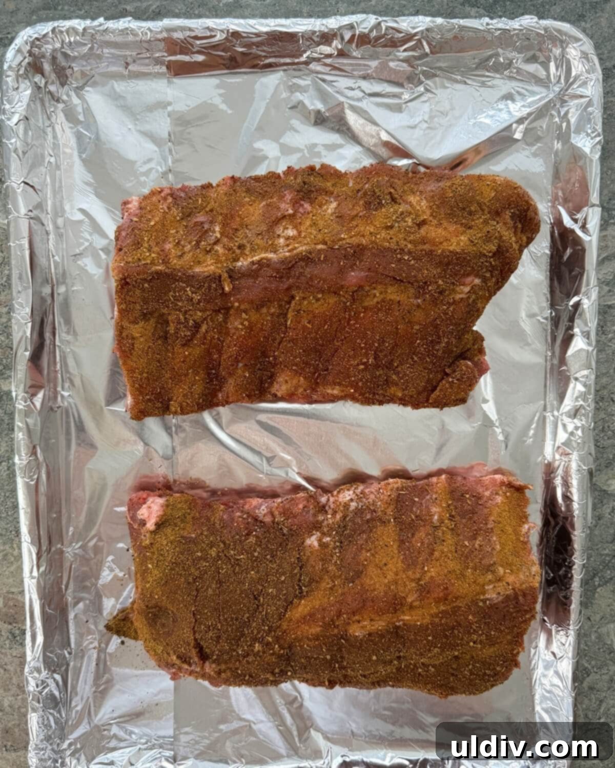 Meltingly Tender Baked Baby Back Ribs 6 Seasoned baby back ribs that are uncooked.