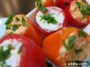 Yaza merhaba: Minik lezzet kesecikleri! 2 Vibrant cheese-filled tomatoes and mini sweet peppers, perfect for a summer appetizer spread.