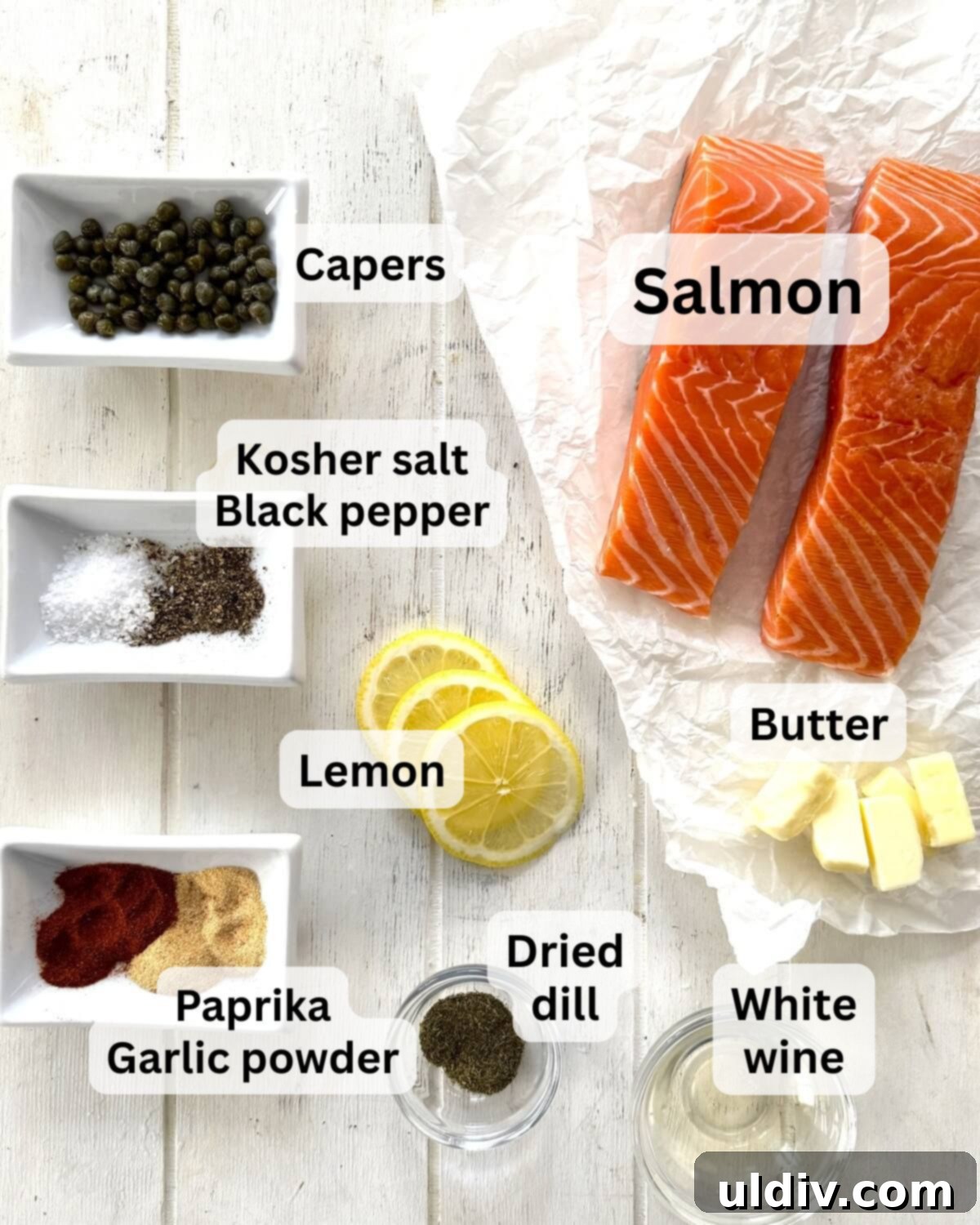 Simple Healthy Foil-Baked Salmon 3 Arrangement of fresh salmon fillets, butter, capers, white wine, lemon slices, and a blend of spices, ready for foil baking.