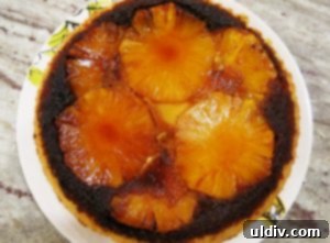 Breaking In My New Cast Iron Skillet with Pineapple Upside-Down Cake 2 A slice of pineapple upside down cake with a rich caramel top