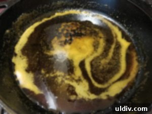 Breaking In My New Cast Iron Skillet with Pineapple Upside-Down Cake 3 Caramelized sugar coating the bottom of a cast iron skillet
