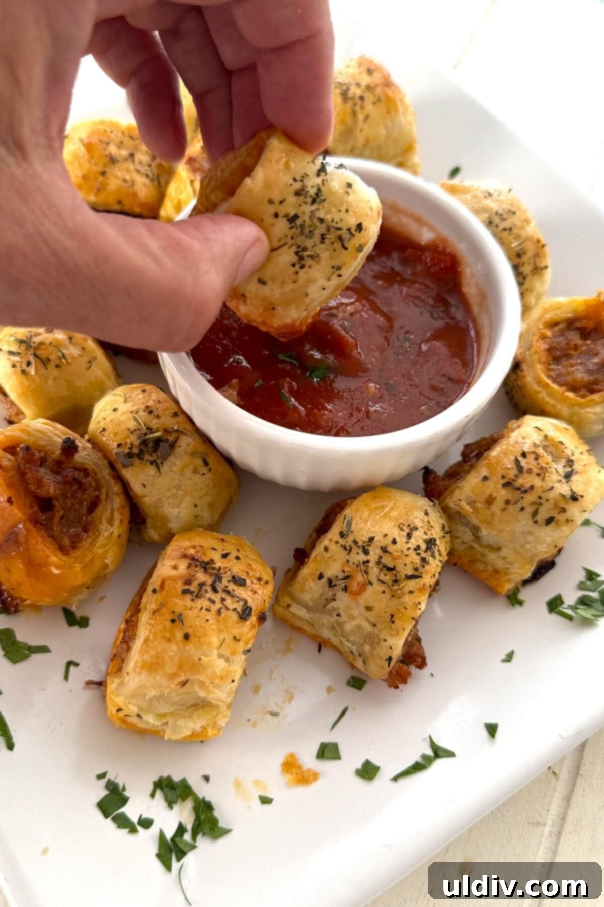 Homemade Pizza Sausage Rolls 2 Dipping a homemade sausage roll in marinara sauce. A perfect snack or appetizer.