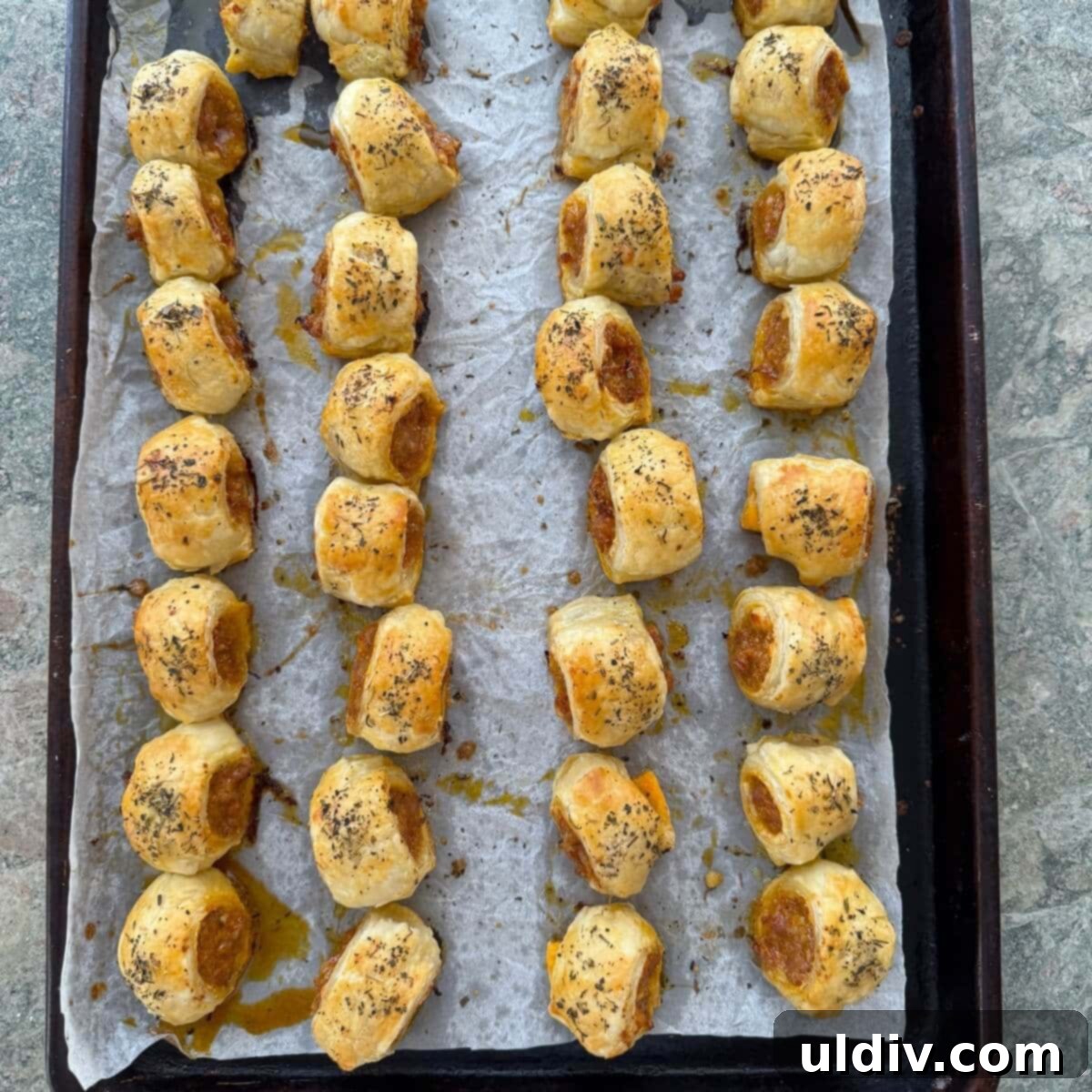 Homemade Pizza Sausage Rolls 11 Baked sausage rolls on a pan, golden brown and crispy.
