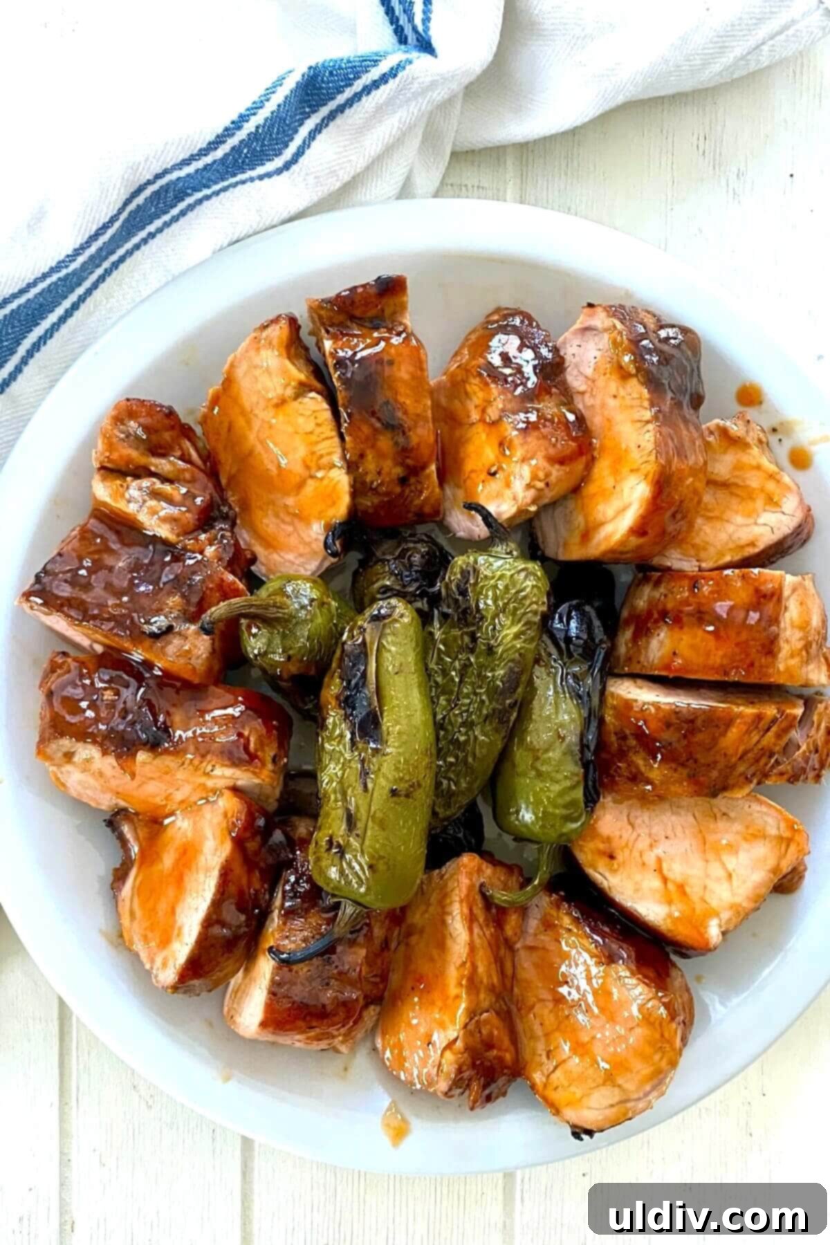 Sweet Heat Pork Tenderloin 2 sliced pork tenderloin with grilled peppers.