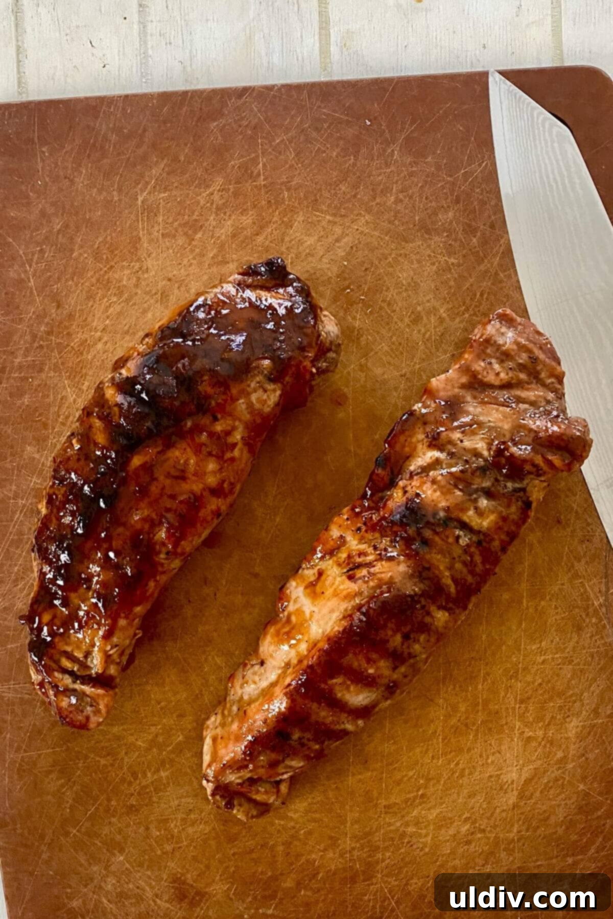 Sweet Heat Pork Tenderloin 8 grilled and glazed pork tenderloin on a cutting board.