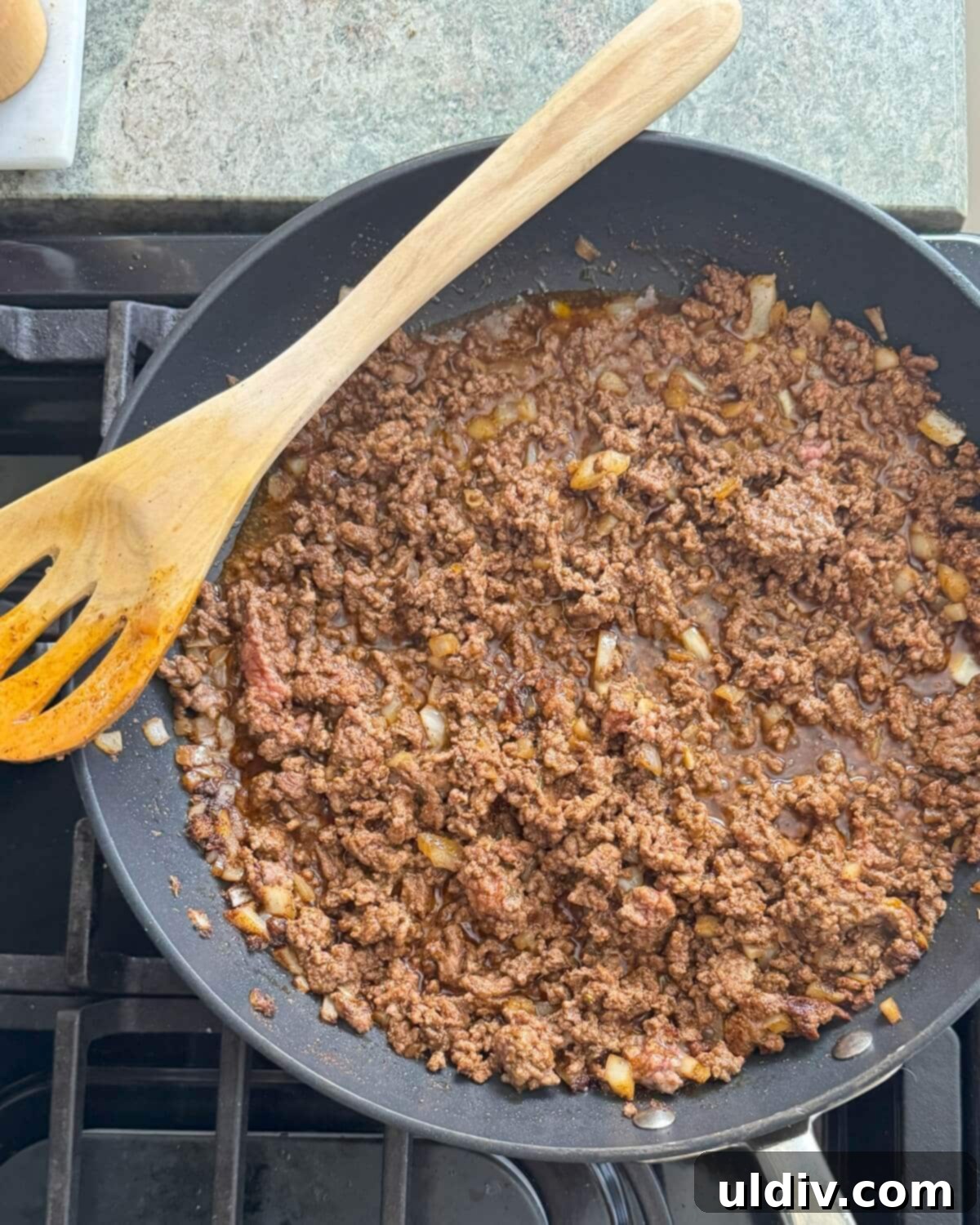 Crispy Baked Taquitos 5 Cooked ground beef mixture with softened onions in a skillet, ready for the next step.