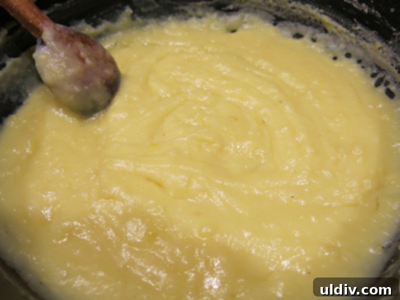 Eclairs Sweet Delights 5 Smooth, thickened pastry cream in a saucepan, with butter being stirred in after cooking.