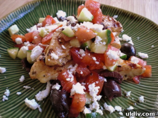 greek chix1 Grilled chicken topped with a salsa of tomatoes, olives, and cucumbers, served alongside.