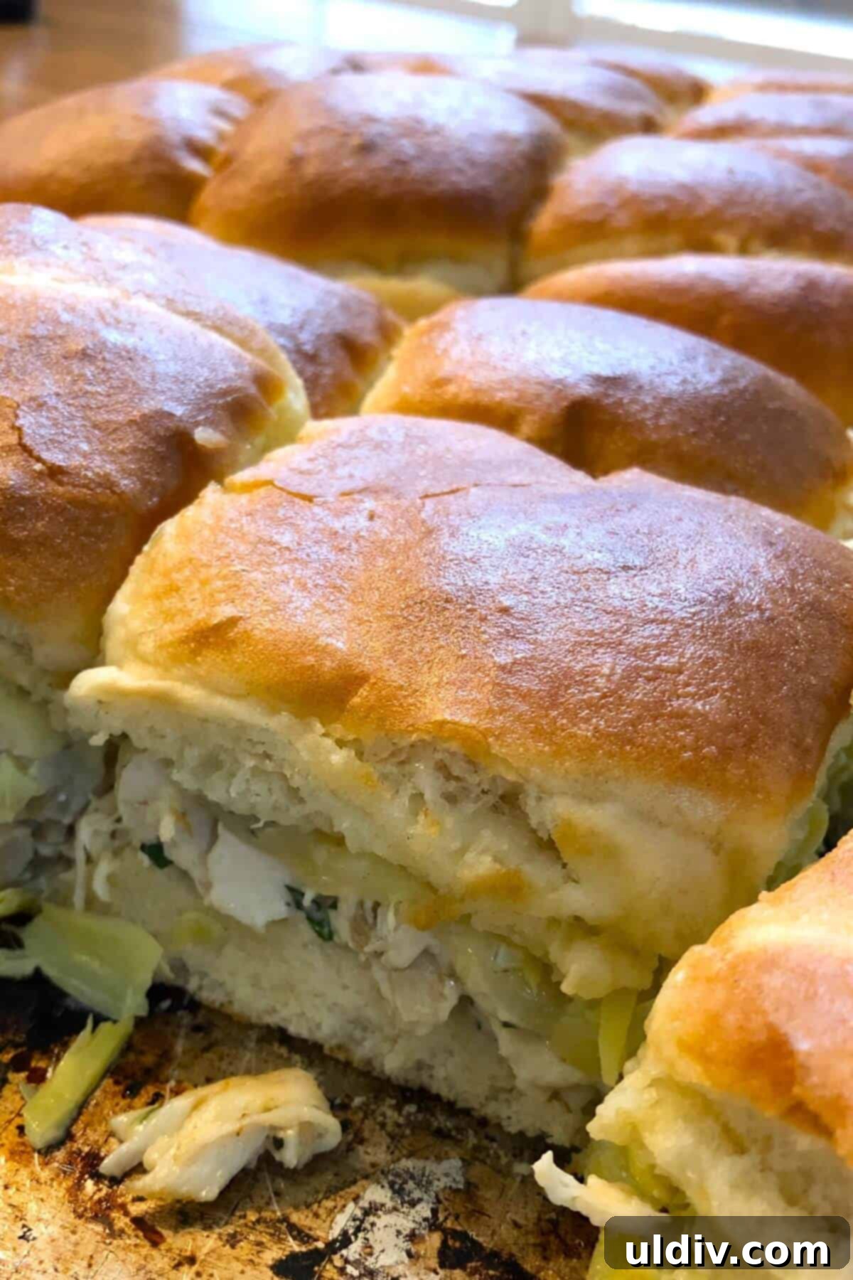 Melty Turkey Sliders with Dreamy Artichoke Dip 3 A baking pan filled with golden-brown turkey sliders, ready to be served.