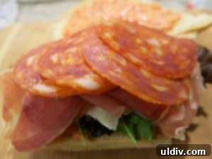 Mediterranean Sunshine Panino: Manchego & Jamón Serrano 8 Sliced chorizo arranged on top of the roast red pepper dip and Jamón Serrano