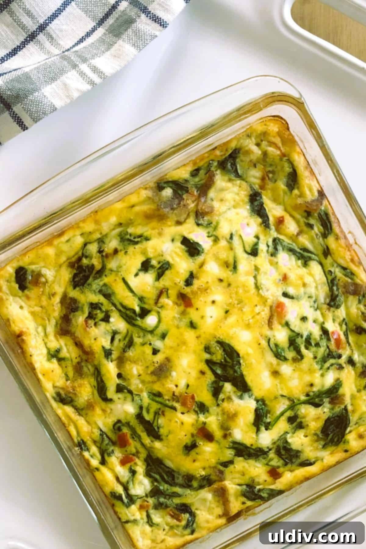 Crustless Spinach Bacon Egg Bites 5 A whole crustless spinach quiche in a baking dish, freshly baked.