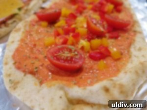 The Naan Sandwich: Decadence, Flavor, and Modern Craze 7 Naan Topped with Mini Peppers, Tomatoes, Pastrami, and Oregano