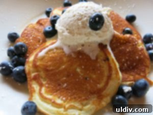 Maggiano's Brunch: Transforming Life's Lemons into Lemon Ricotta Pancake Perfection 8 A delightful platter of lemon ricotta pancakes, garnished with fresh fruit and syrup