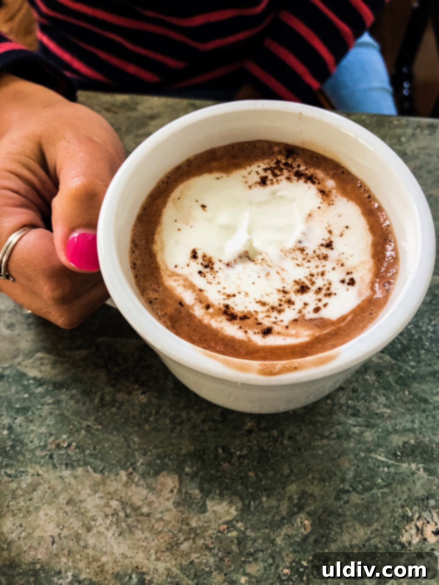 Indulgent Hot Chocolate Blend 4 woman holding mug of hot cocoa with homemade whipped cream