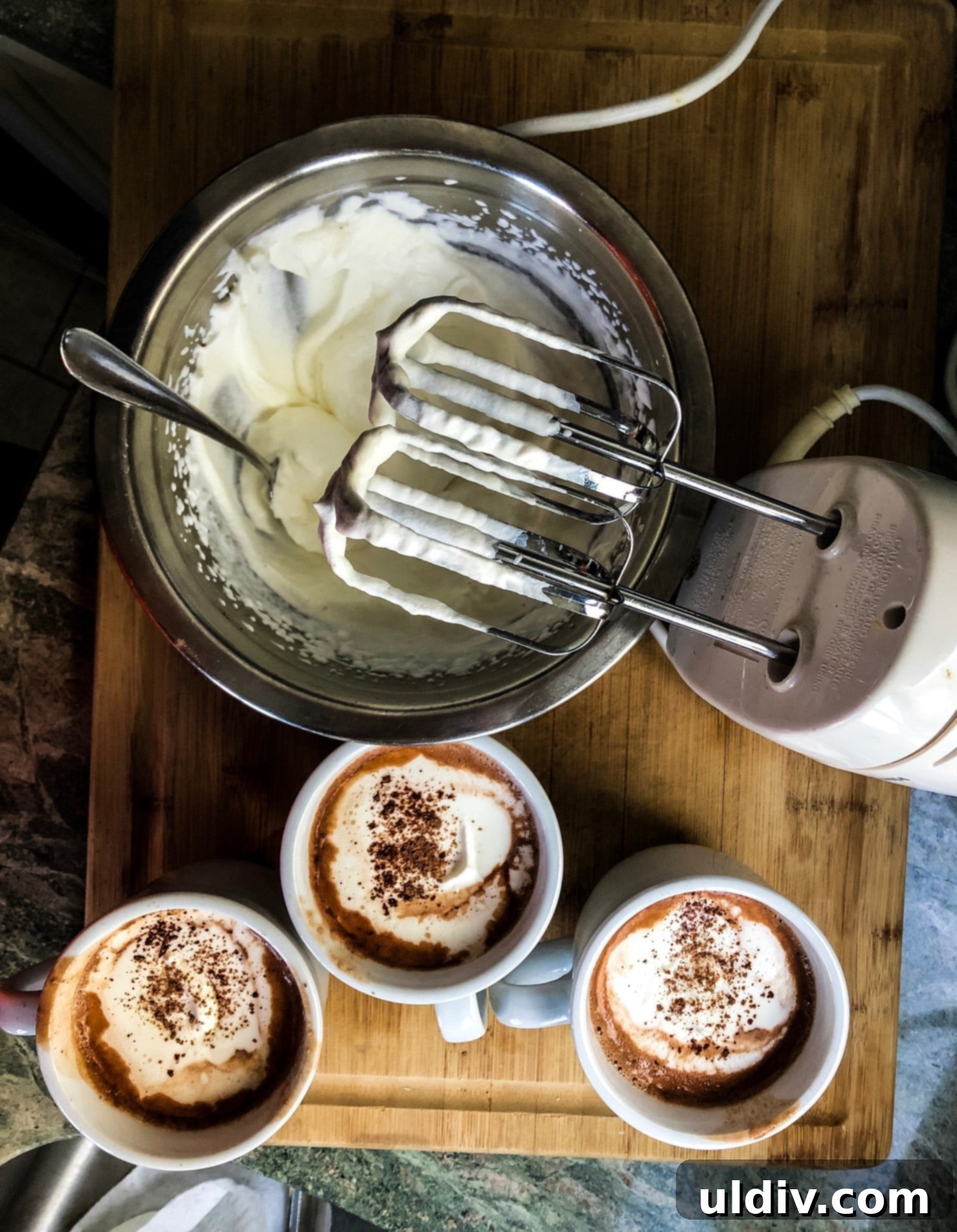 Indulgent Hot Chocolate Blend 6 3 mugs of hot cocoa with a bowl of homemade whipped cream and hand mixer
