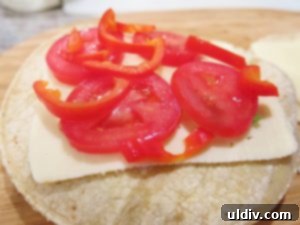 Cinco de Mayo Weekend Double Stacked Tortilla Sandwich Feast 9 Second corn tortilla stack with another slice of Chihuahua cheese, and the remaining sliced tomatoes and mini red pepper.