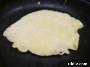 Sweetest Mom, Sweetest Treat: Decadent Mango Crepes for Mother's Day 9 Cooking a crepe in a pan until golden brown