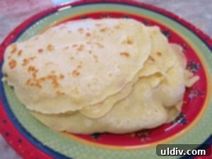 Sweetest Mom, Sweetest Treat: Decadent Mango Crepes for Mother's Day 10 Stack of freshly cooked crepes cooling on a plate