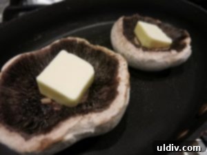 Easy Breezy Cheesy Veggie Sandwich With a Goat Cheese Zing 4 Portobello mushroom caps sizzling in a pan with butter and seasoning