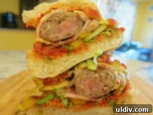 Memorial Day Sausage Sandwich Sizzle Not Your Average Pigs in a Blanket 2 Grilled sausage sandwich with bacon and melted pepper jack cheese on a roll