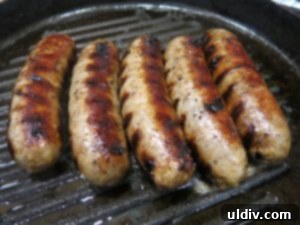 Memorial Day Sausage Sandwich Sizzle Not Your Average Pigs in a Blanket 4 Grilled sausages cooling on a plate