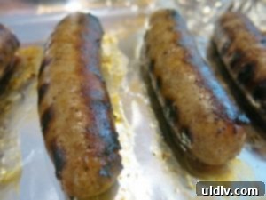 Memorial Day Sausage Sandwich Sizzle Not Your Average Pigs in a Blanket 5 Sausages wrapped in bacon, ready for the oven