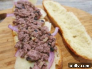 Generous amount of blended meat and mushroom mixture on red onion