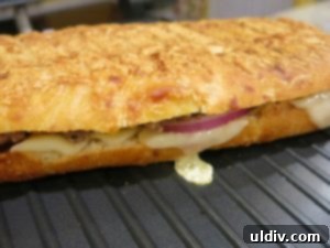 Panino grilling on a hot grill until golden brown and crispy