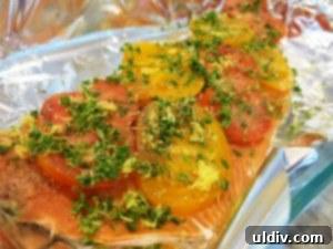 Delicious Salmon Heirloom Tomatoes and Millet A Feast of Freshness and Life 7 Close-up of fresh herbs and lemon zest sprinkled over salmon and sliced tomatoes, ready for baking