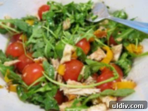 Lighten Up Your 4th of July Grill: Chicken, Tomato, and Arugula Salad for Burgers and Dogs 6 Shredded roast chicken ready for a vibrant salad